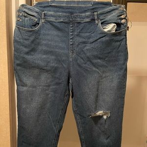 Woman’s blue jean overalls. Brand new, distressed leg.